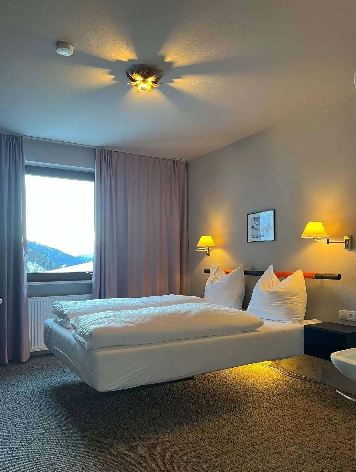 Albona Nest: bed by the window with a view of the slope