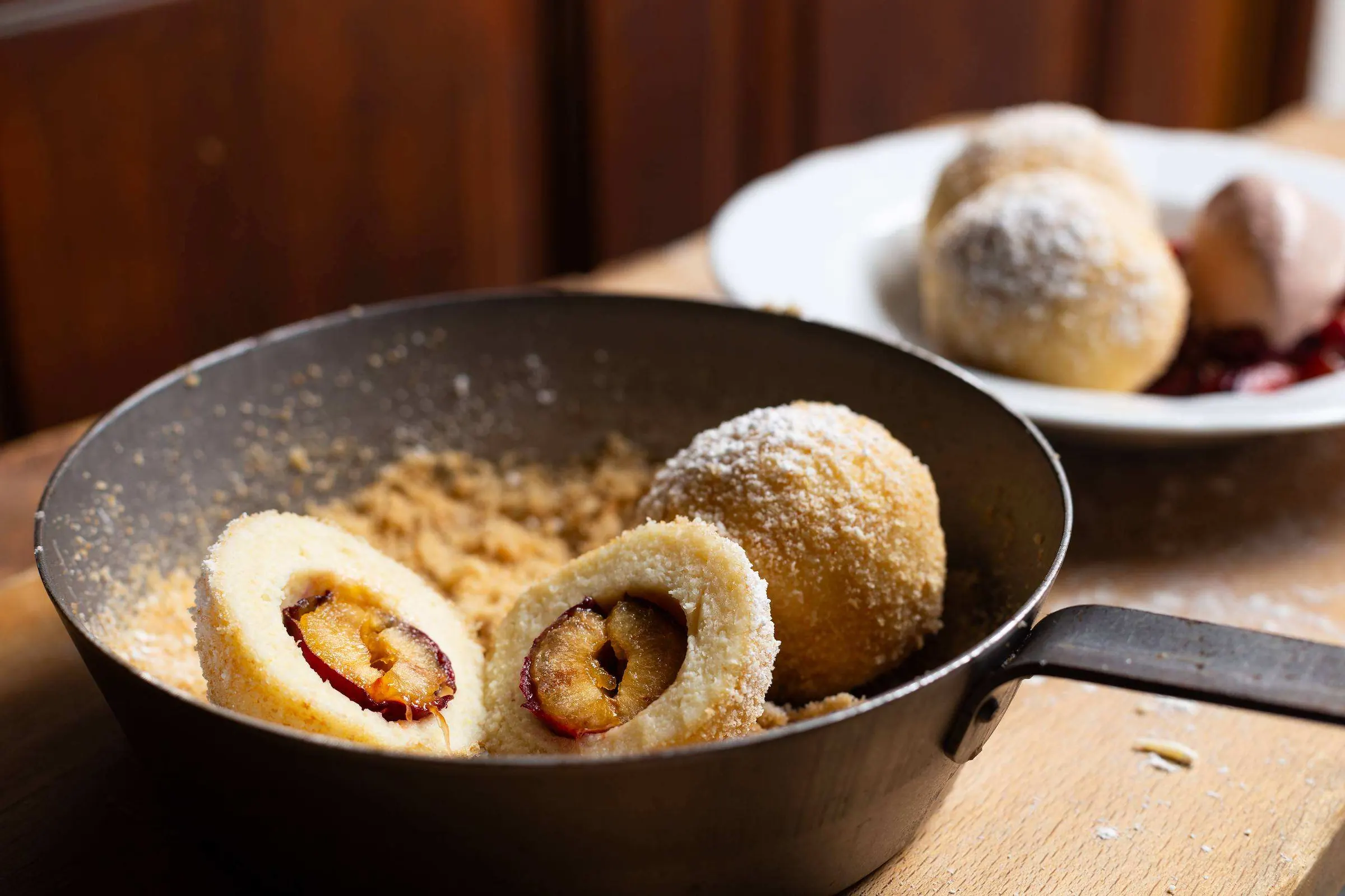 Plum dumplings in a cast-iron pan