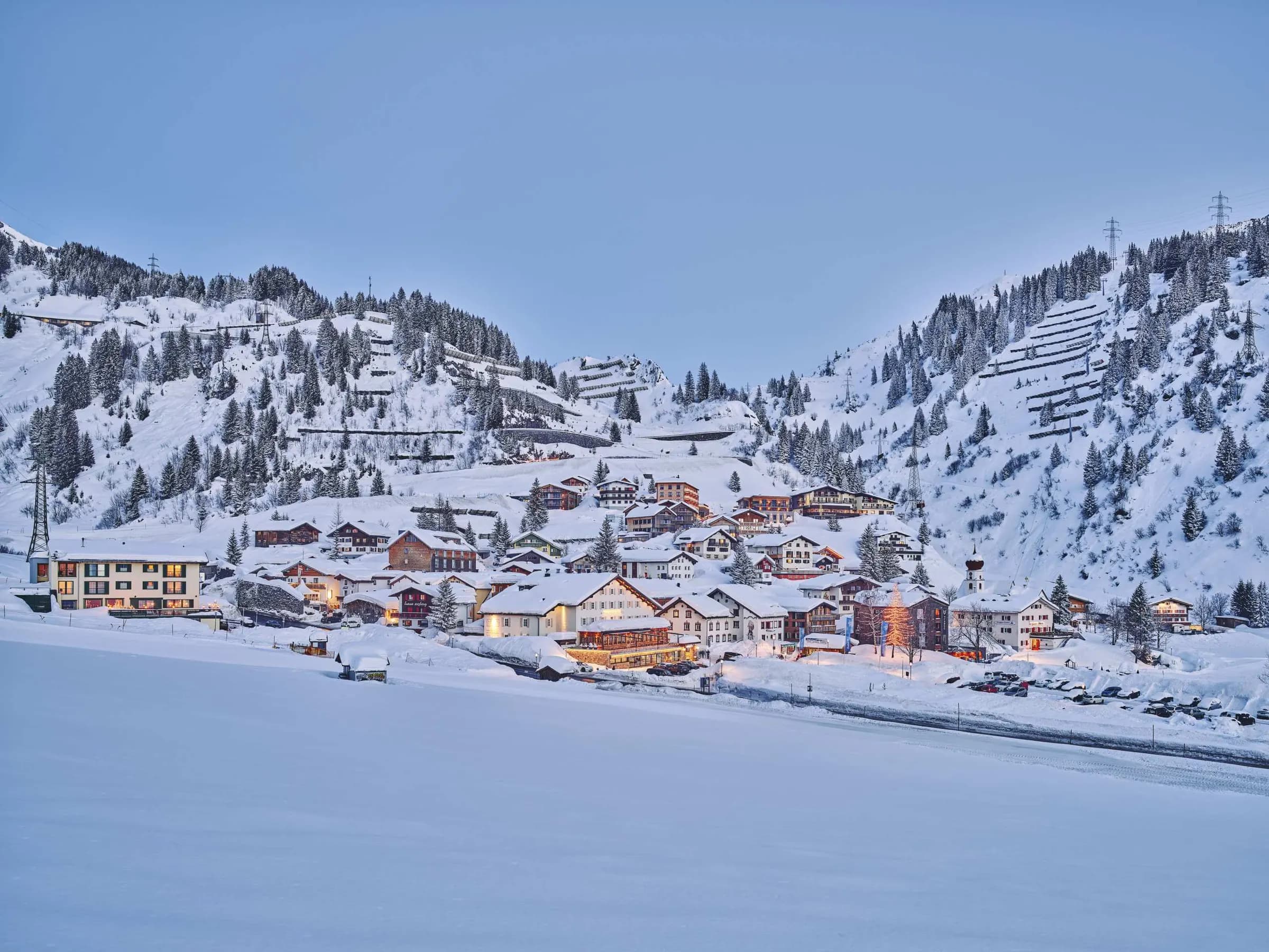 Stuben at blue hour, lit houses under deep snow