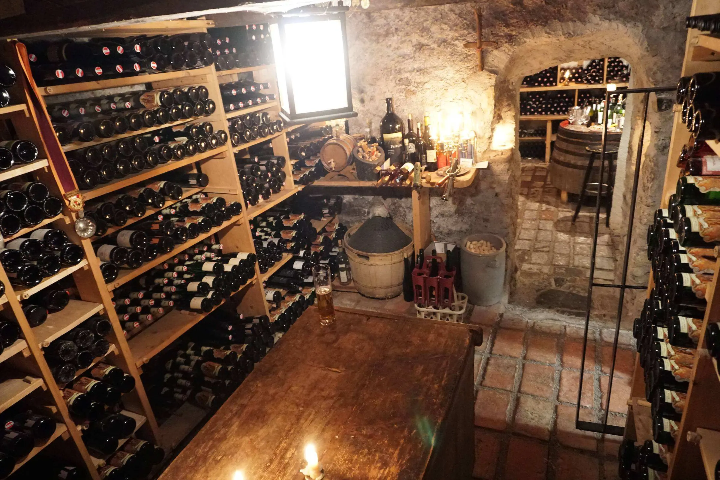 Vaulted wine cellar with a table and a candle