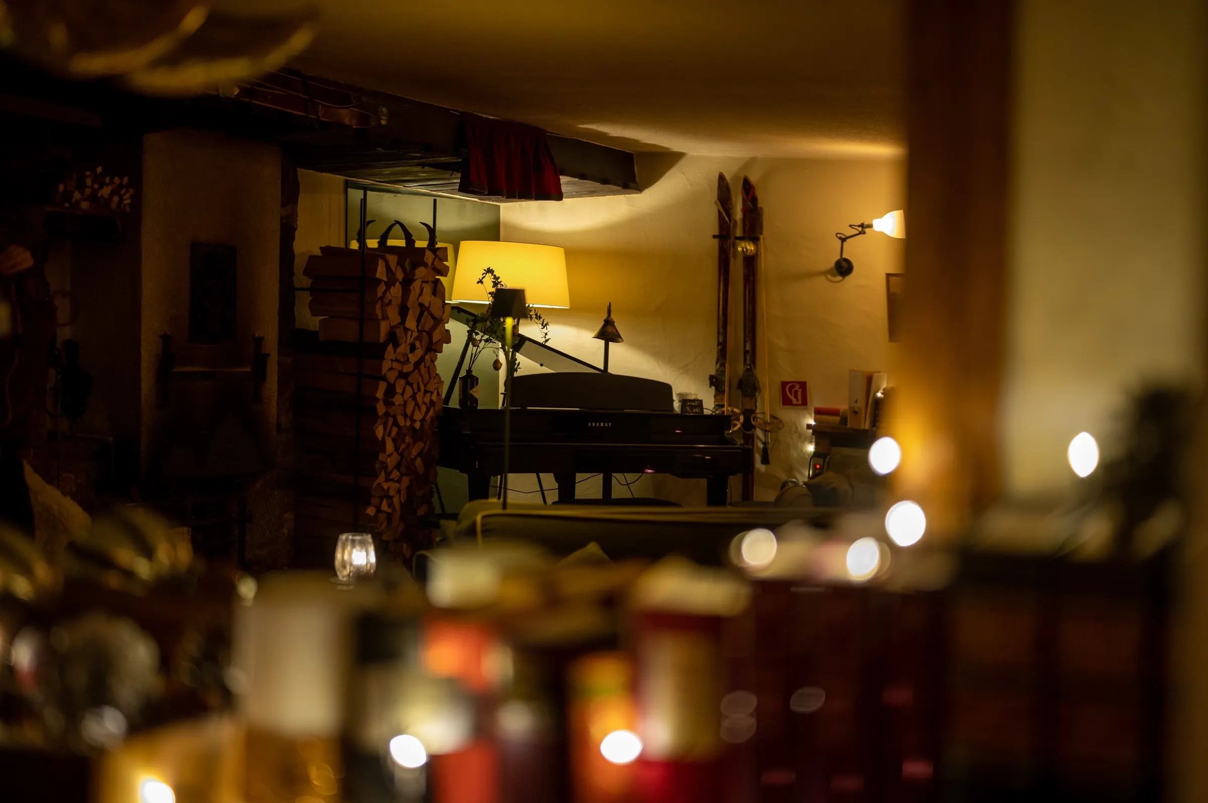 Lamps and candlelight in a dining room at night