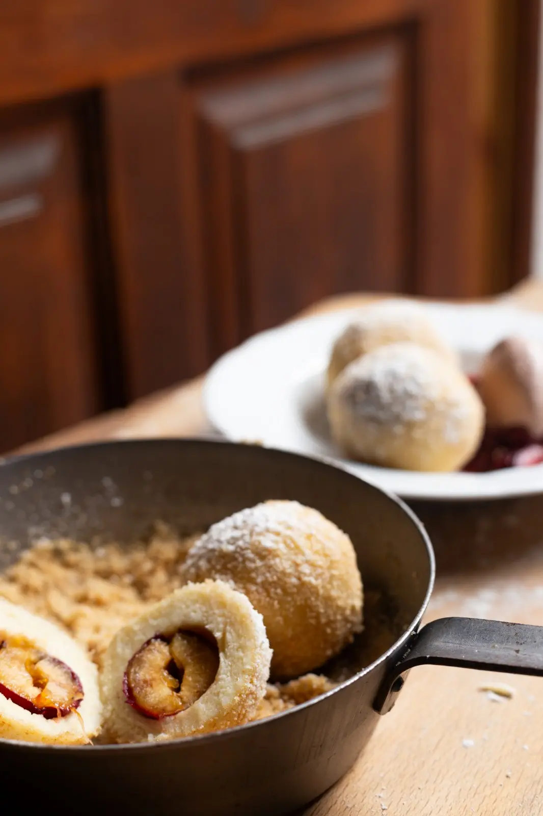 Homemade Austrian Marillenknödel with breadcrumbs and powdered sugar, served in Mondschein’s Alte Gaststube at Ski-Hotel Mondschein in Stuben am Arlberg