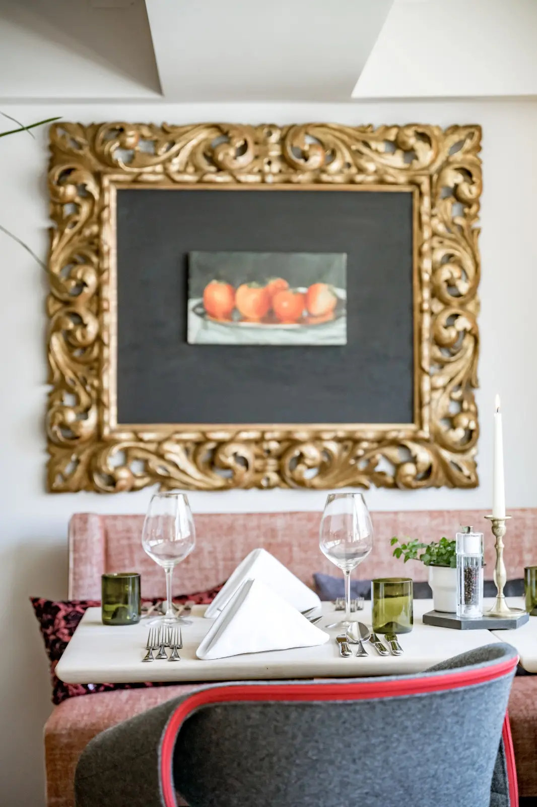 Elegant table for two at the Panorama Restaurant of Ski-Hotel Mondschein with gold-framed still life artwork and alpine-chic interior