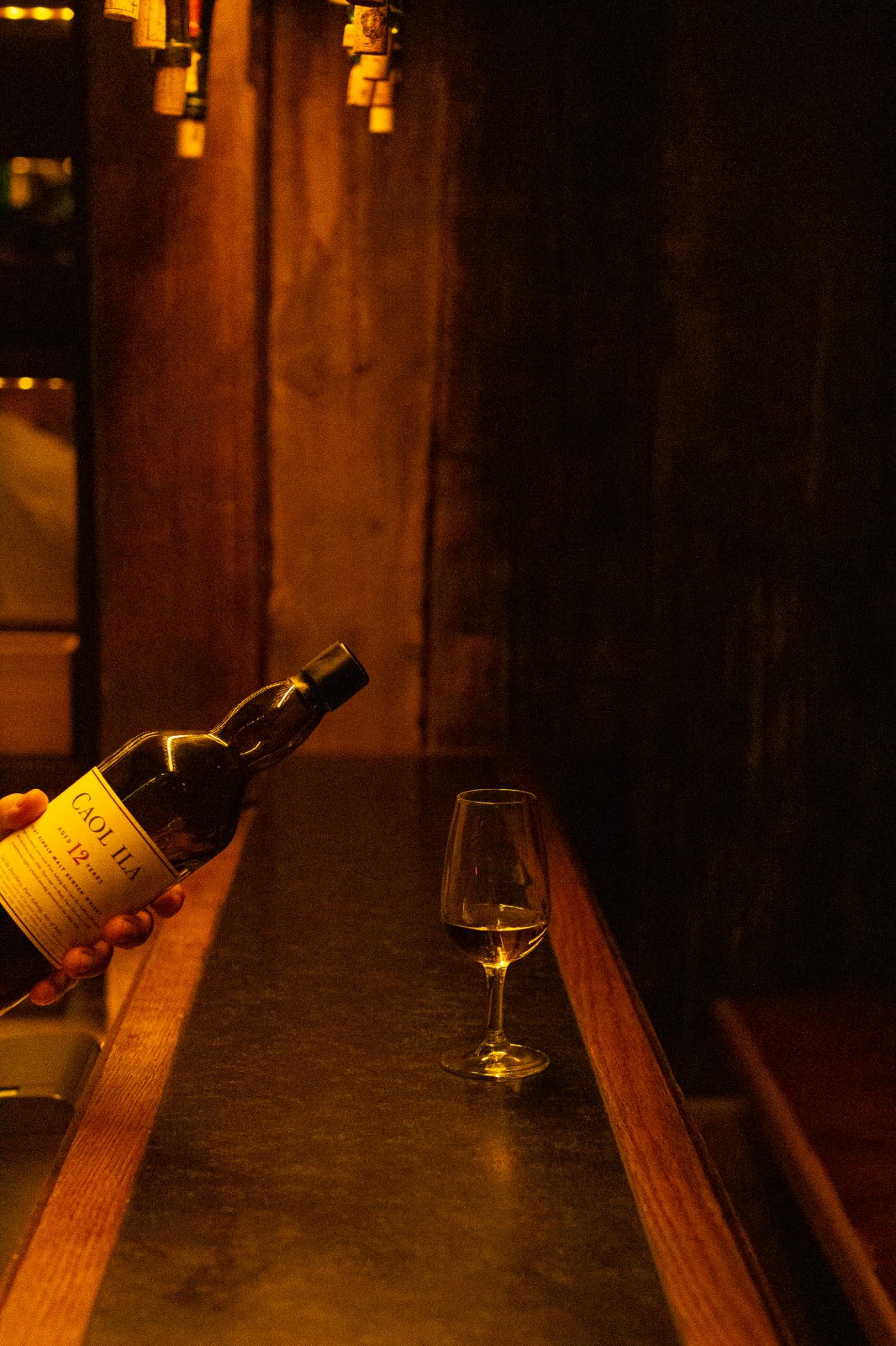 Inviting fireplace lounge with stacked firewood, vintage décor, cozy armchairs and red plaid cushions at Ski-Hotel Mondschein in Stuben am Arlberg