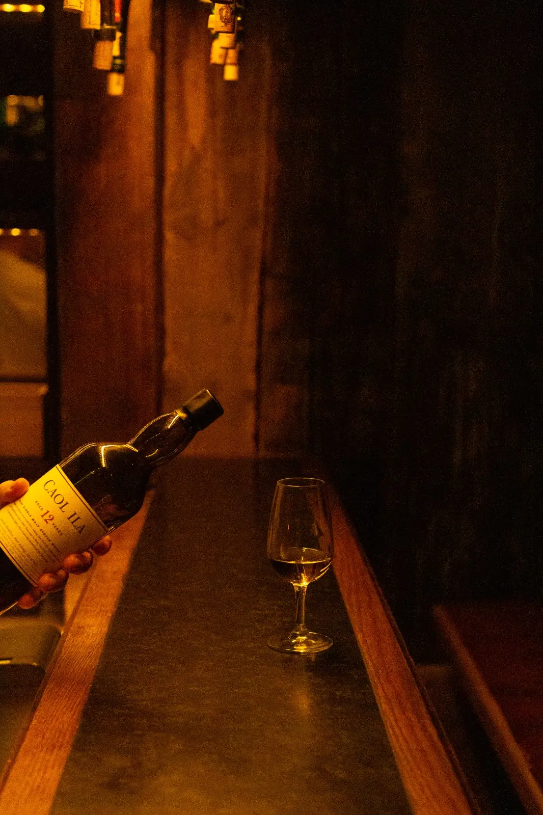 Inviting fireplace lounge with stacked firewood, vintage décor, cozy armchairs and red plaid cushions at Ski-Hotel Mondschein in Stuben am Arlberg