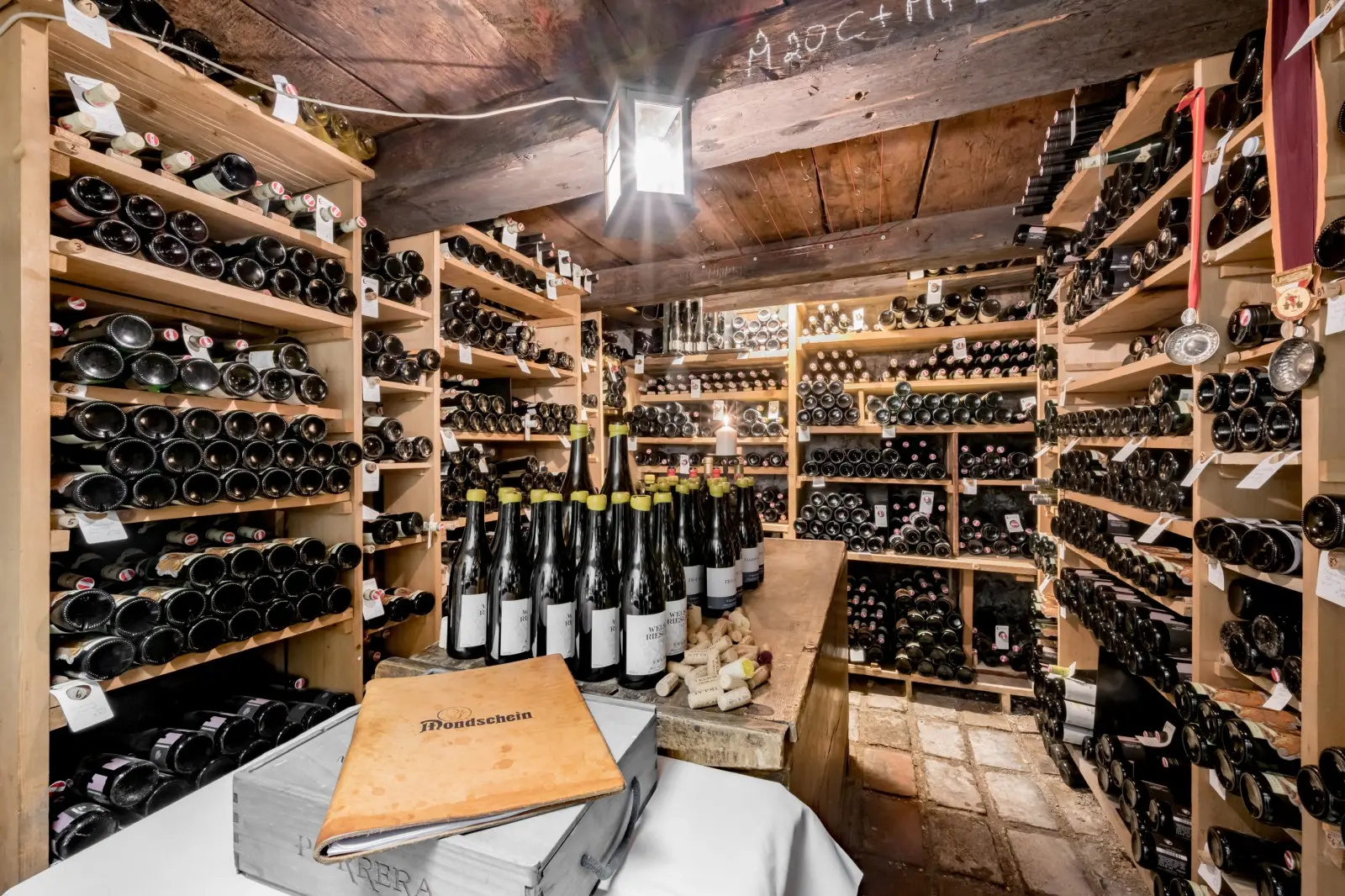 Green bottles of Knoll wine neatly stored in the cellar of Ski-Hotel Mondschein in Stuben am Arlberg