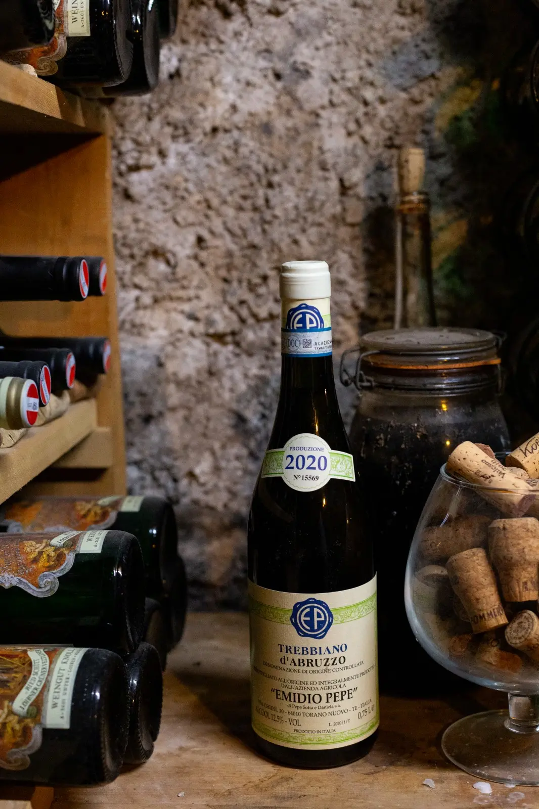 Wine cellar at Ski-Hotel Mondschein with hundreds of vintage bottles, a wooden tasting table, and curated wine list