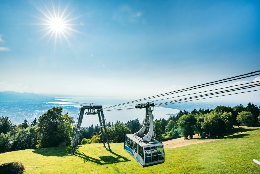 Pfänder cable car arriving at the mountain station above Bregenz, Austria, on a sunny summer day with panoramic views over Lake Constance and the surrounding landscape